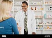 Woman picking up prescription drugs at pharmacy Stock Photo - Alamy