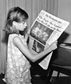 Image 39A girl reading a 21 July 1969 copy of The Washington Post reporting on the Apollo 11 Moon landing (from Newspaper)