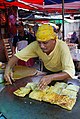 Image 105Murtabak being made at a stall, a type of pancake filled with eggs, small chunks of meat and onions. (from Malaysian cuisine)