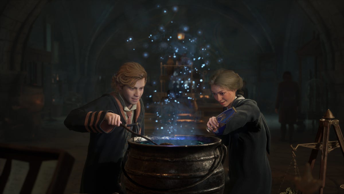 Two students mix a potion and sparks fly out of a cauldron in Hogwarts Legacy