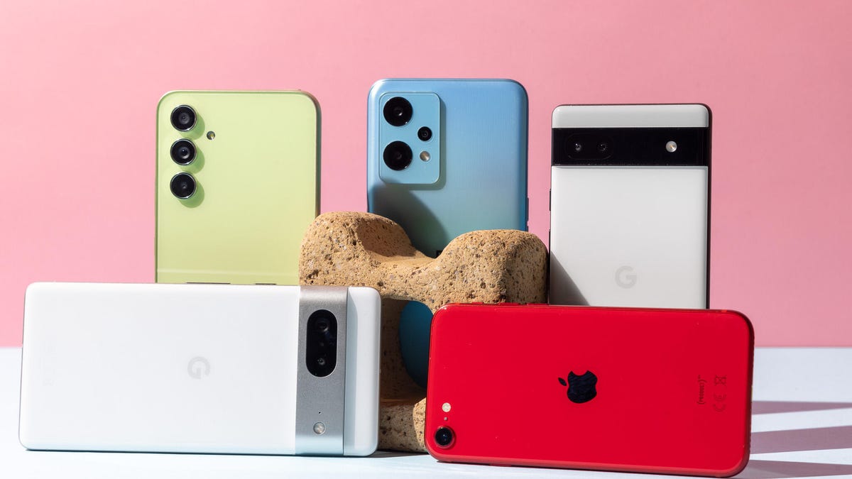 A bunch of phones against a pink background