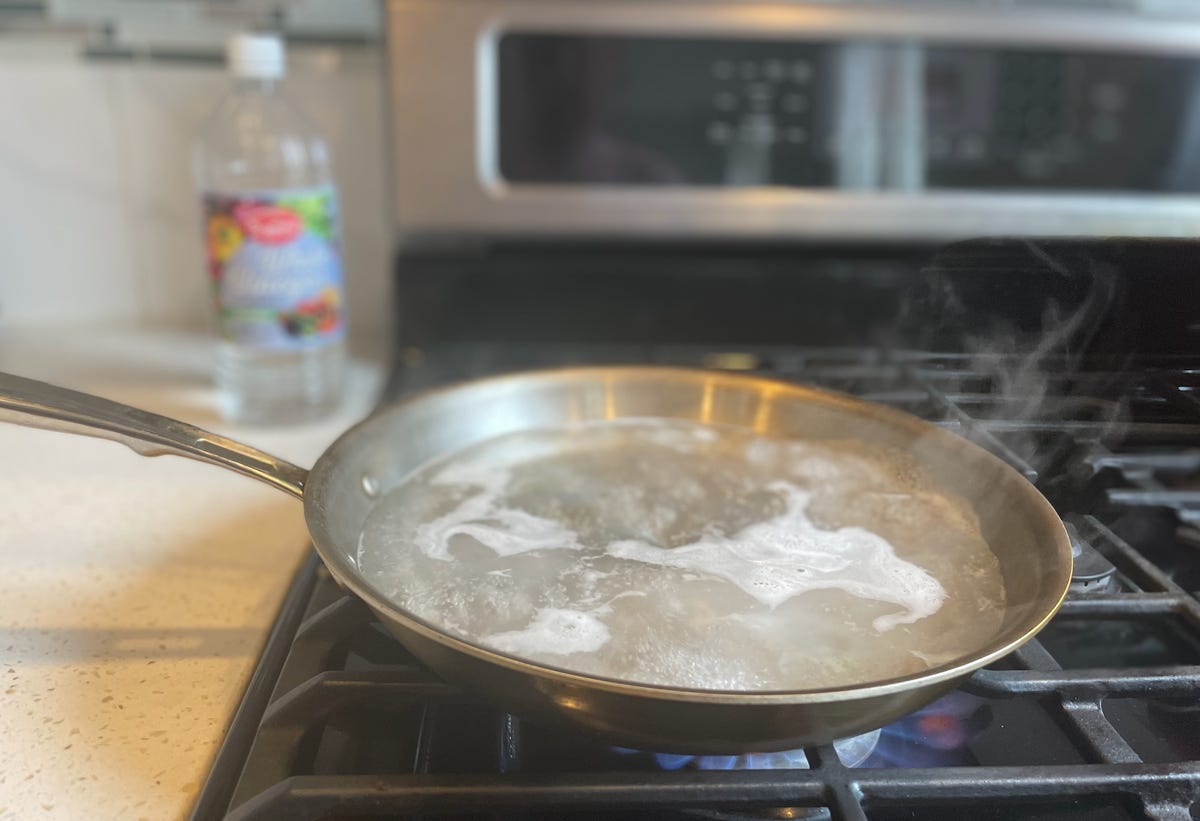 skillet with boiling water on stove