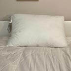 Casper Original Pillow on a white bed.