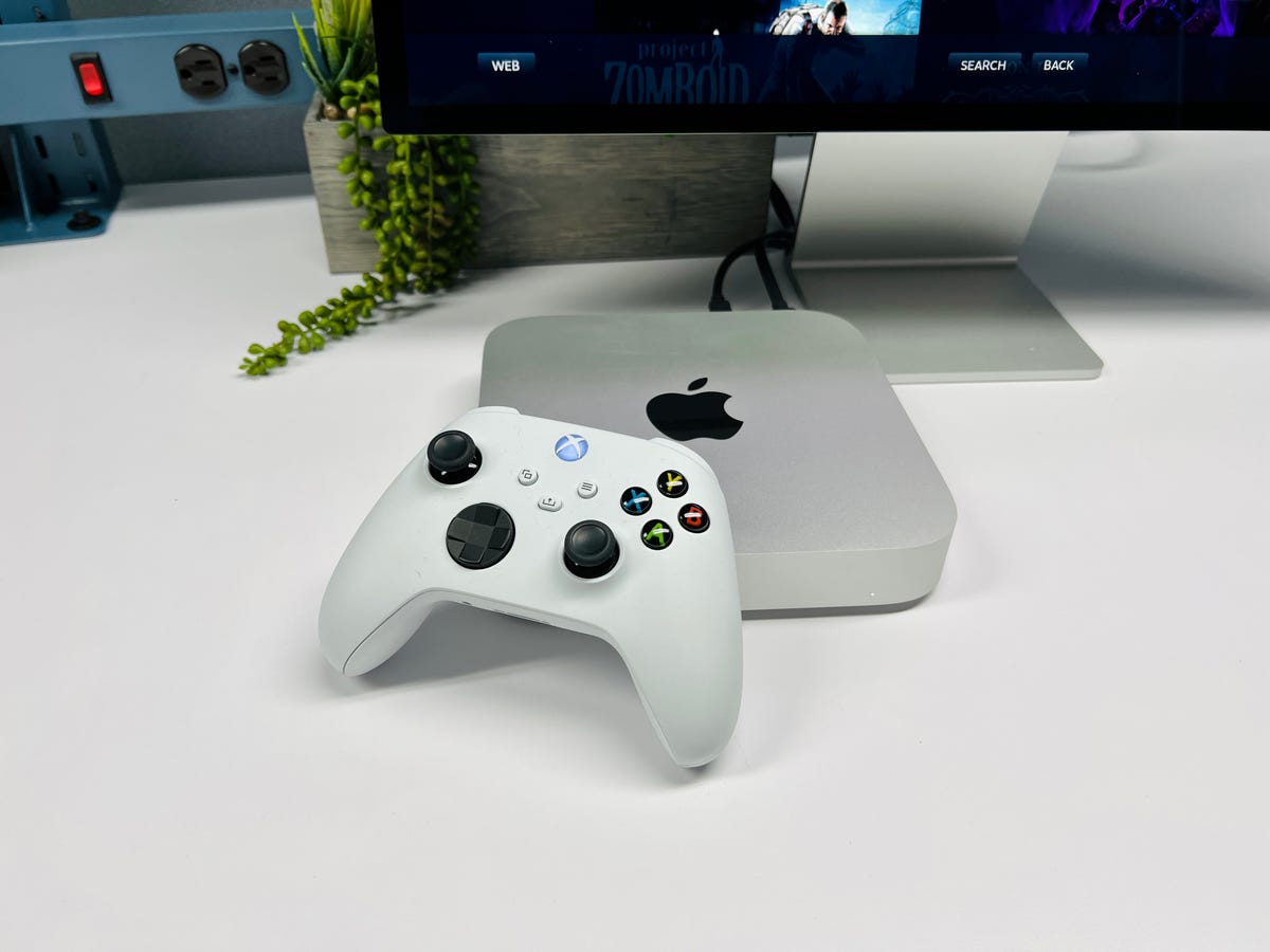 Game controller next to small computer