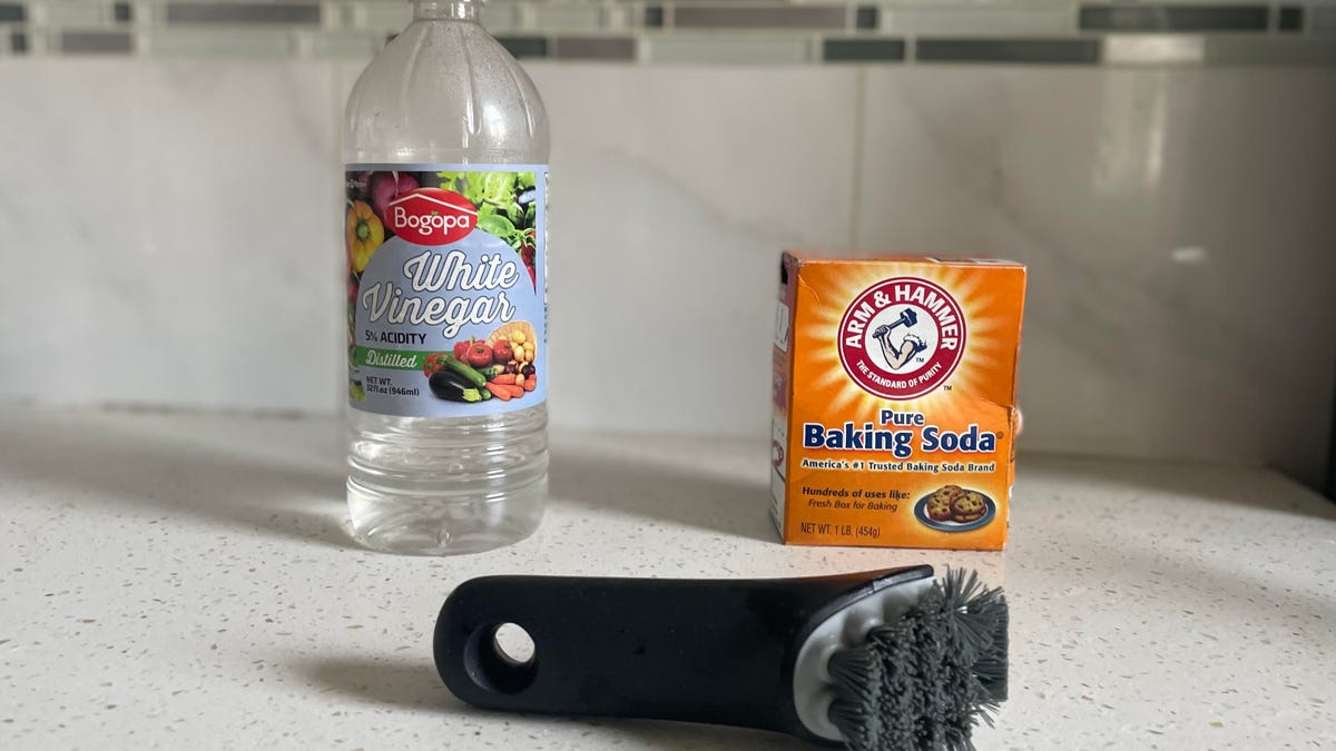 baking soda white vinegar and scrub brush on counter