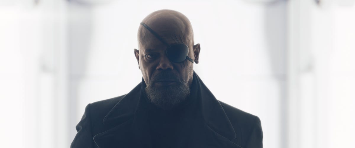 Midshot of Samuel L. Jackson as Nick Fury, looking right at us with bright light in the background