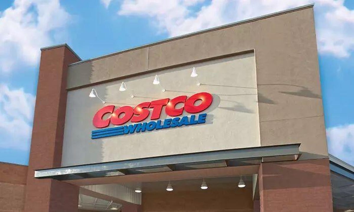 The red Costco logo on a brown storefront