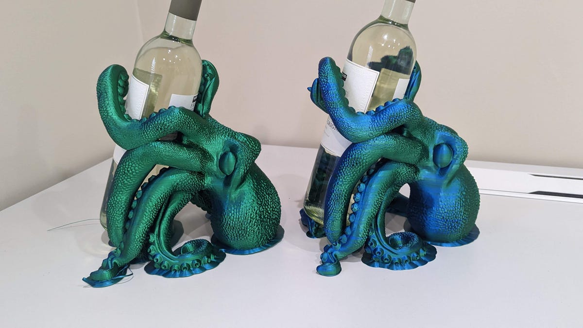 Two octopi both alike in dignity with wine bottles in their arms