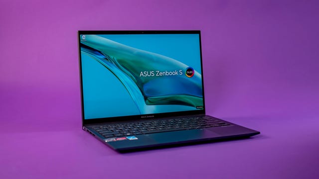 Asus Zenbook S 13 OLED UM5302 laptop open on a purple background.