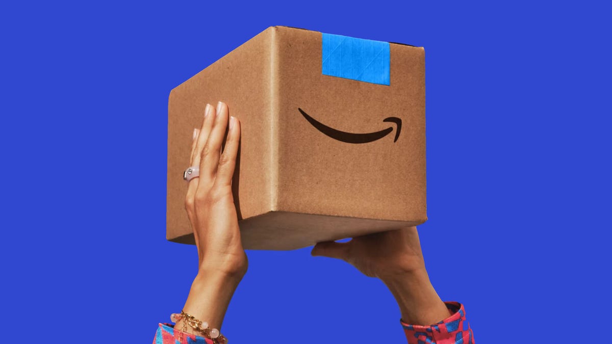 two hands holding an Amazon Prime box