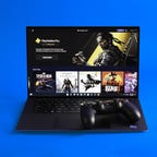 PlayStation Plus Premium home screen on the Dell XPS 15 with the DualShock 4 controller on the keyboard
