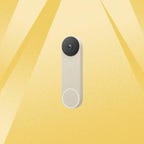 A beige Google Nest Doorbell against a yellow background.