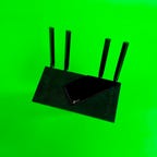 TP-Link Archer AX21 wi-fi router on a green background.