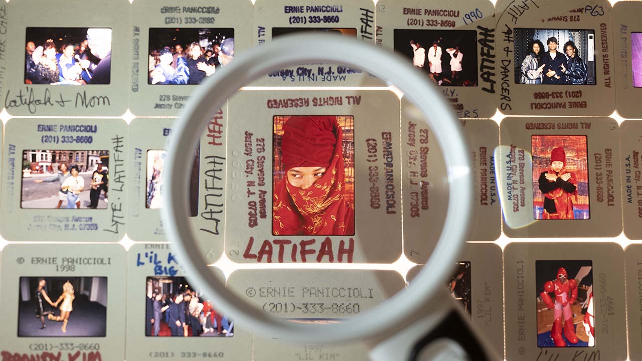 A collection of slides from the Hip Hop Collection, with a magnifying glass over a portrait of Queen Latifah.