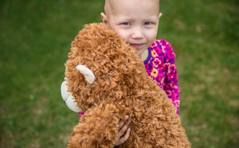 Eva hugging her teddy bear