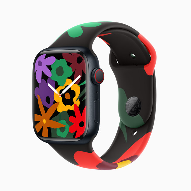 Imagem do Apple Watch Series 9 com a nova pulseira e mostrador da Coleção Black Unity; nesta imagem, o mostrador tem várias flores em diferentes cores.
