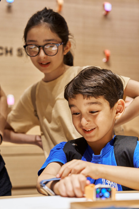 Two young customers explore the latest Apple Watch lineup.