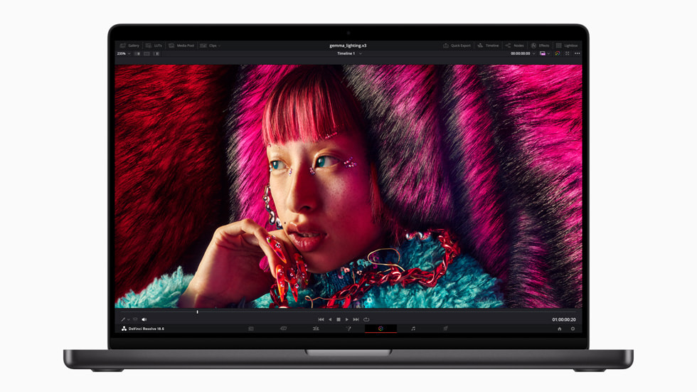 A person with pink hair is shown on the new MacBook Pro as part of a video editing workflow.