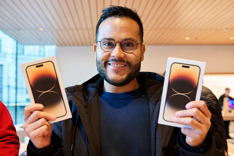 A customer shows off their new iPhone 14 Pro Max purchases at the new Apple Pacific Centre in Vancouver, Canada.