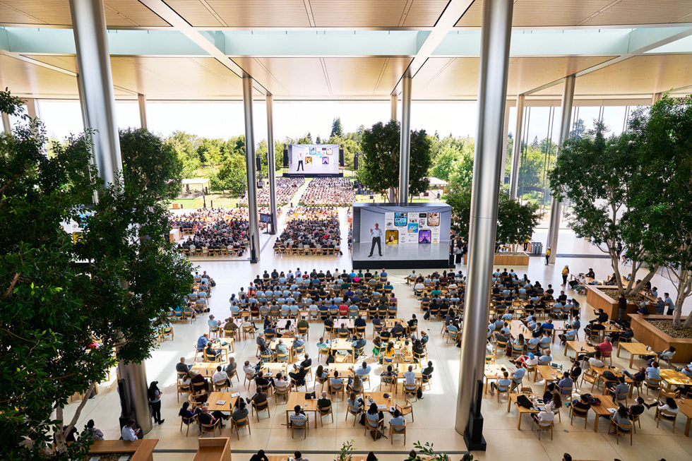 Uczestnicy konferencji WWDC22 oglądają premierę systemu iOS 16 na kampusie Apple Park.