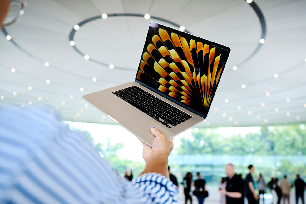 WWDC 기간 동안 참석자가 Apple Park에서 MacBook Air 15를 들어보고 있다. 