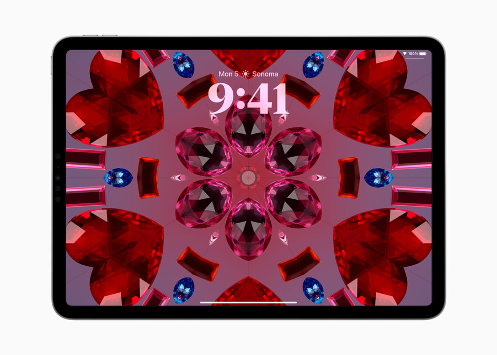 iPad Pro shows the kaleidoscope wallpaper.