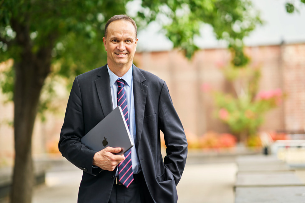 Professor Ian Burnett, RMIT’s deputy vice-chancellor and vice-president of STEM College, holding a MacBook.