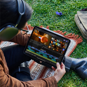 A person uses Final Cut Pro for iPad outdoors.