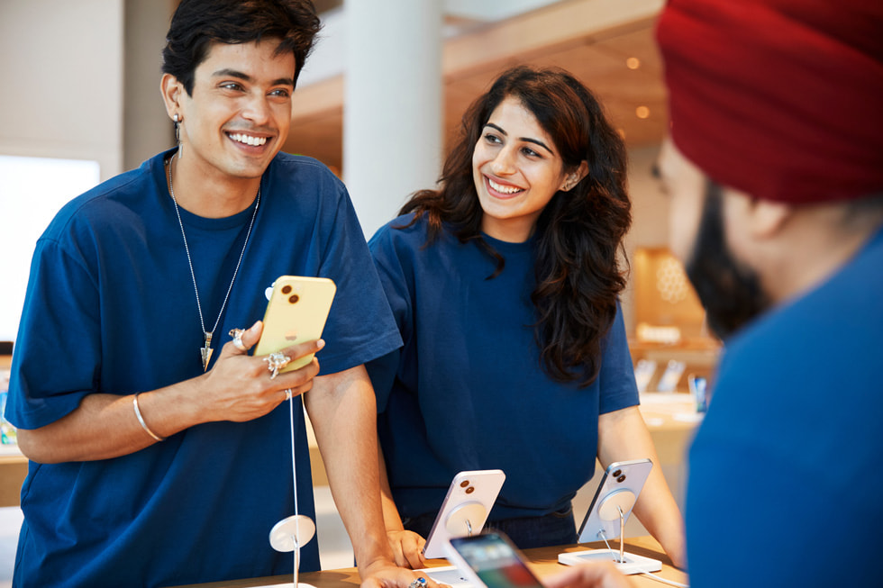 Apple BKC team members stand at the dedicated Apple Pickup area inside the store.