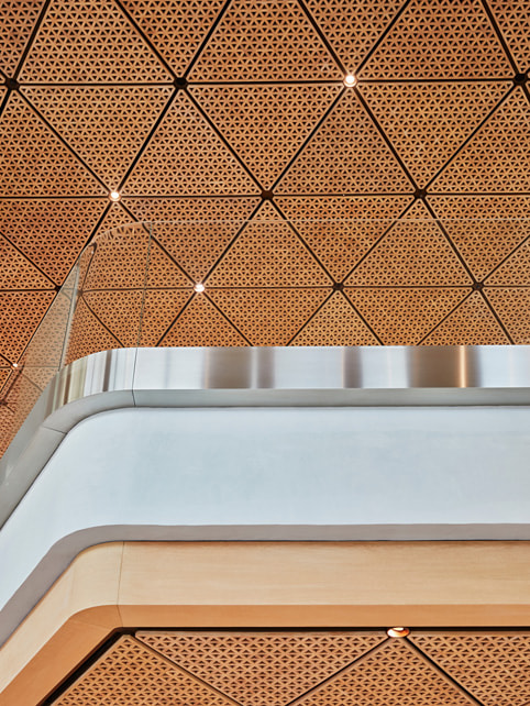 A close-up shot of Apple BKC’s triangular timber ceiling.