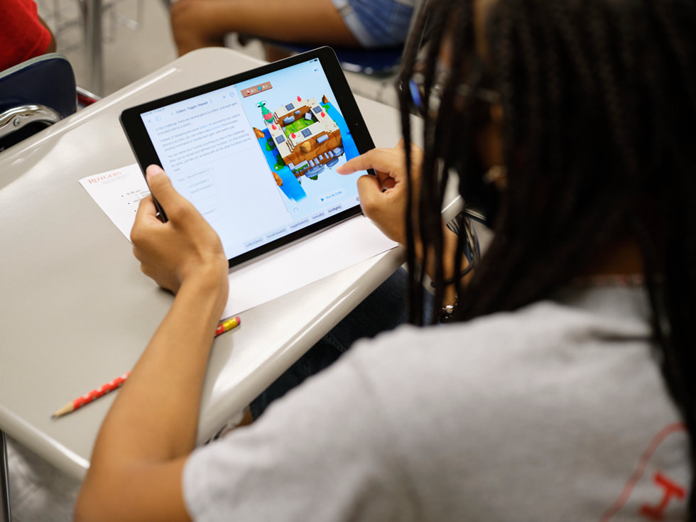 A student at the Rutgers 4-H Computers Pathways Program uses an iPad in a classroom setting.