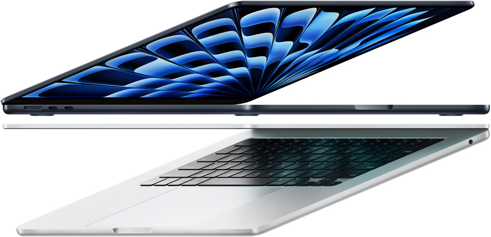 Partially open 13-inch MacBook Air on left and 15-inch MacBook Air on right. 13-inch screen shows colourful ‘zine cover created with In Design. 15-inch screen shows Microsoft Excel and Slack.