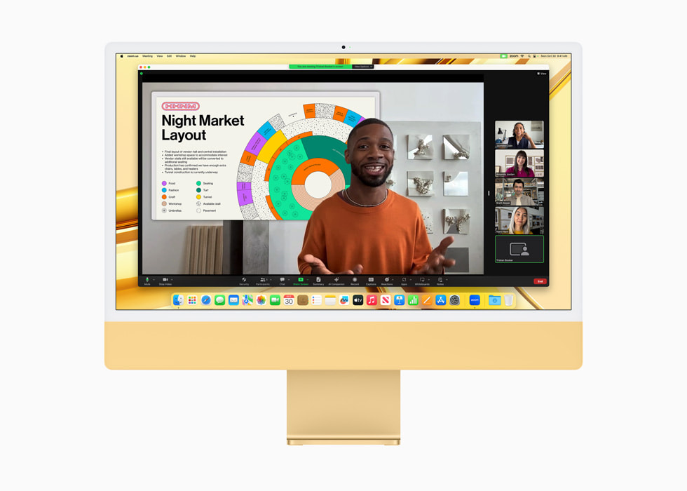 图中是视频会议的画面，显示在搭载 M3 芯片的黄色新款 iMac 的显示屏上。