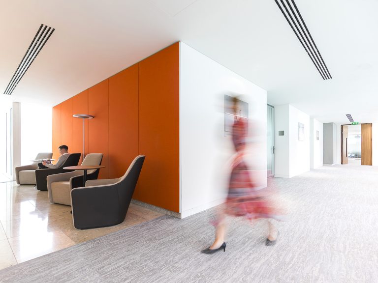 orange wall, corridor, person walking