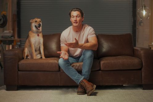 tyler cameron on couch with dog