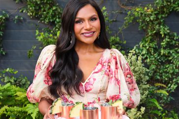 Mindy Kaling holding drink tray for House Rules