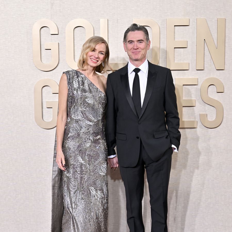 Naomi Watts and Billy Crudup holding hands and smiling on 2024 Golden Globes red carpet
