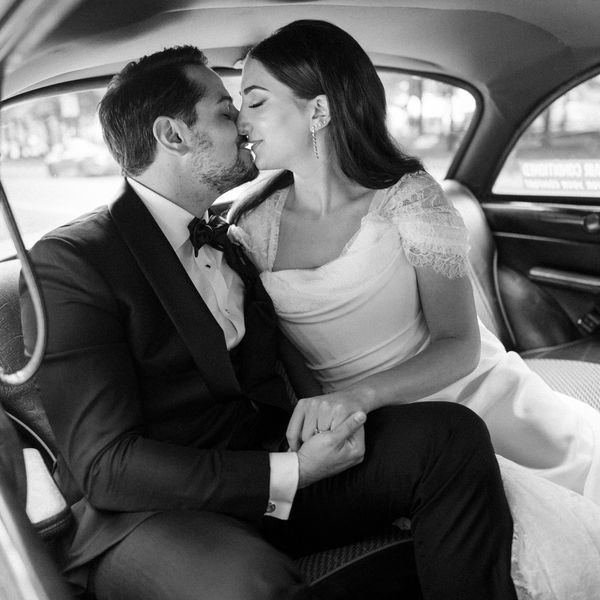 Bride in Wedding Dress With Lace Sleeves and Groom in Tuxedo in Taxi Cab