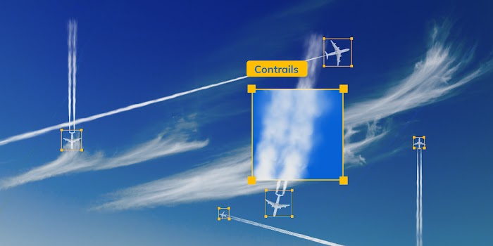 Airplanes fly across a blue sky with contrails trailing behind