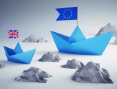 Picture of two paper boats - one with a European flag and the other with a British flag