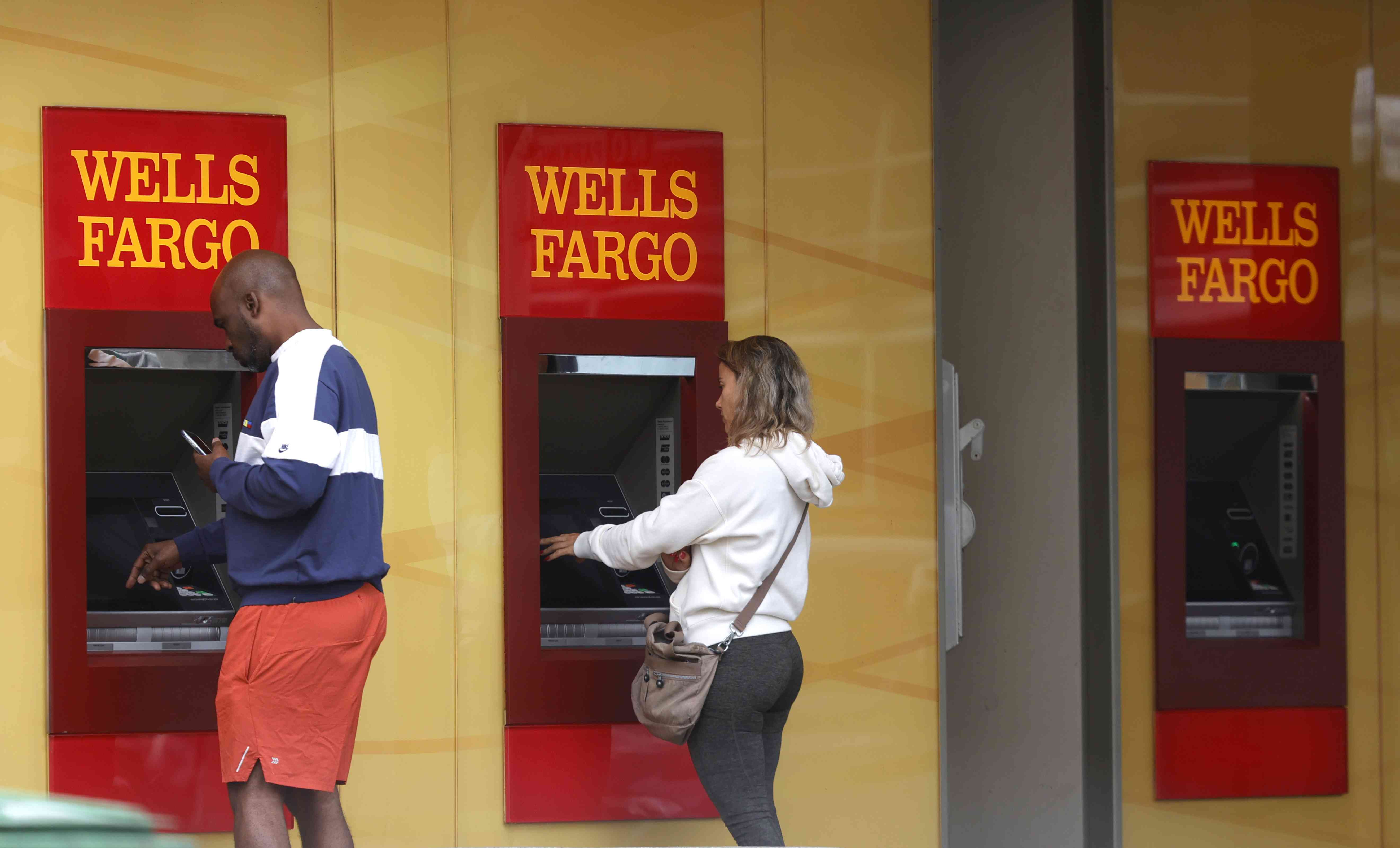 Wells Fargo customers use ATMs outside of a Wells Fargo bank on July 14, 2021 in San Francisco, California.