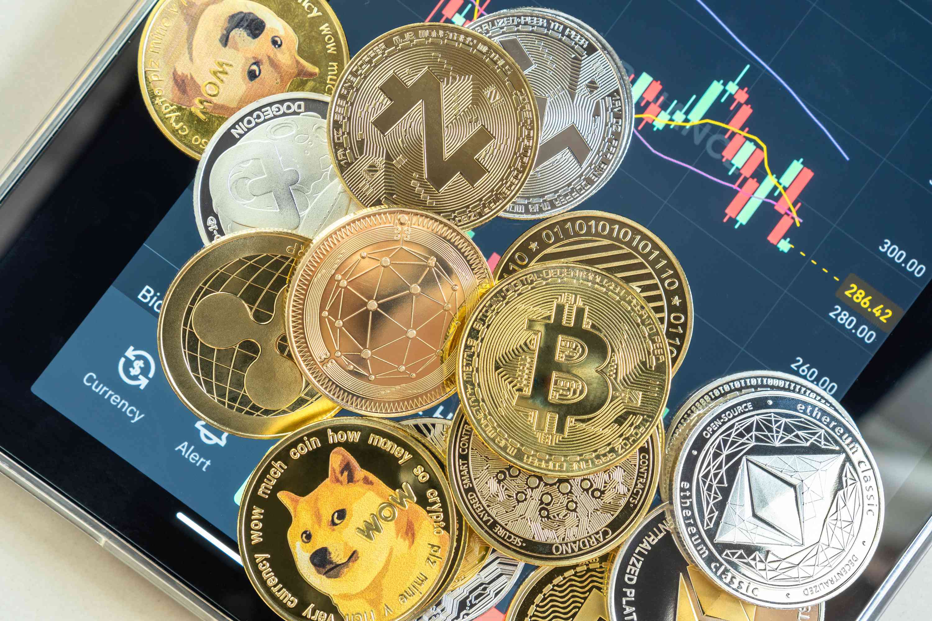 Cryptocurrency coins over tablet with trading app