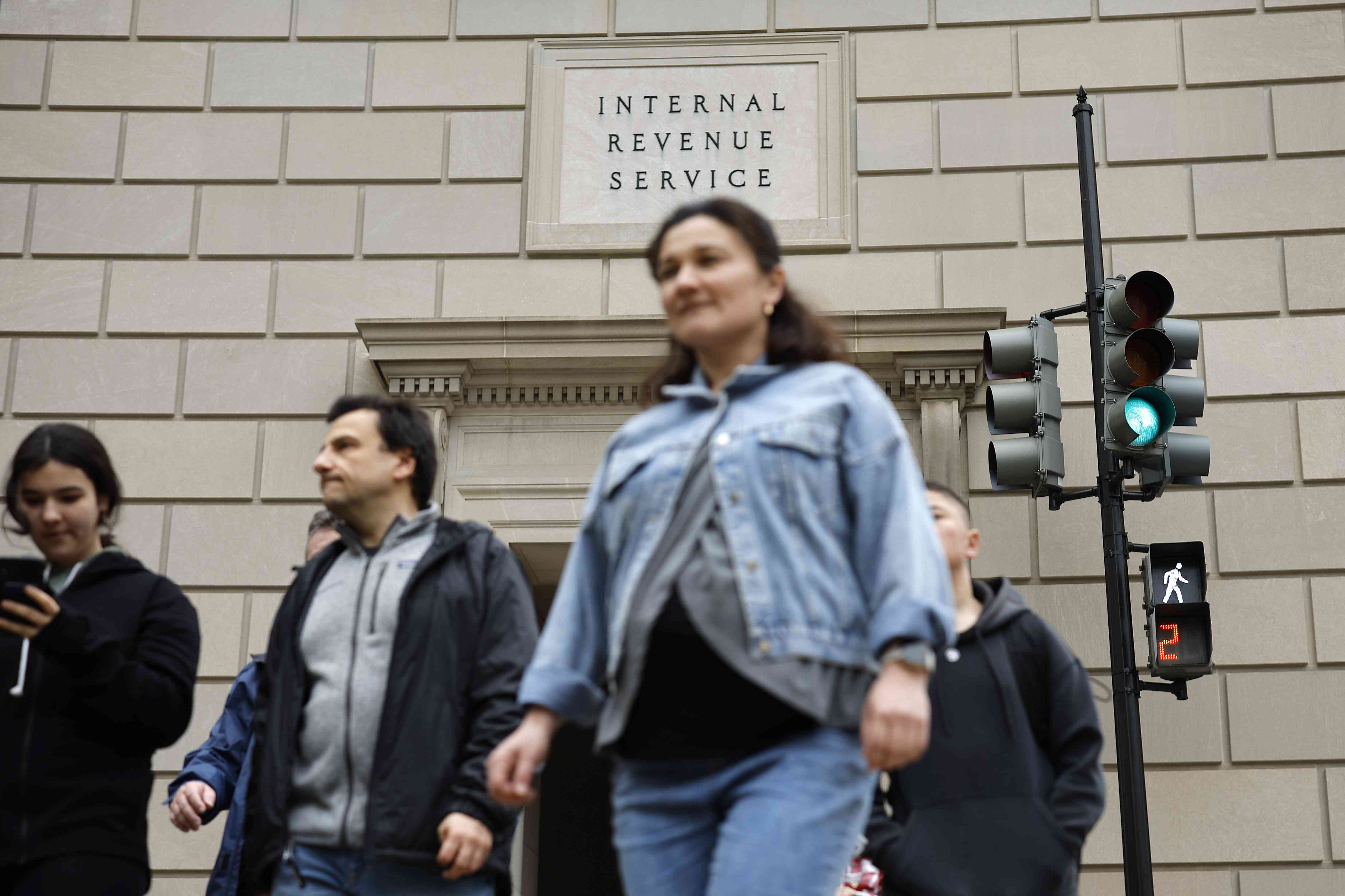 People walk outside of the Internal Revenue Service headquarters in Washington, DC.