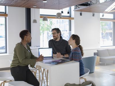 Three people in an office meeting