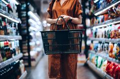 Cropped shot of woman carrying a shopping cart in a grocery store
