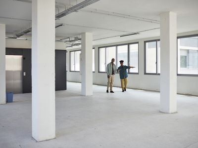 Commercial real estate broker showing a client office space