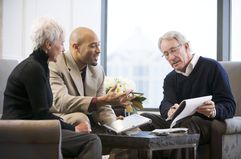 Older couple discussing paperwork with a young man