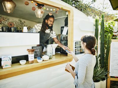 Food truck owner takes credit card payment from customer