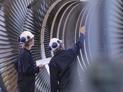 Engineers, representing operating expenses (OpEx), work on a turbine, representing capital expenditures (CapEx).