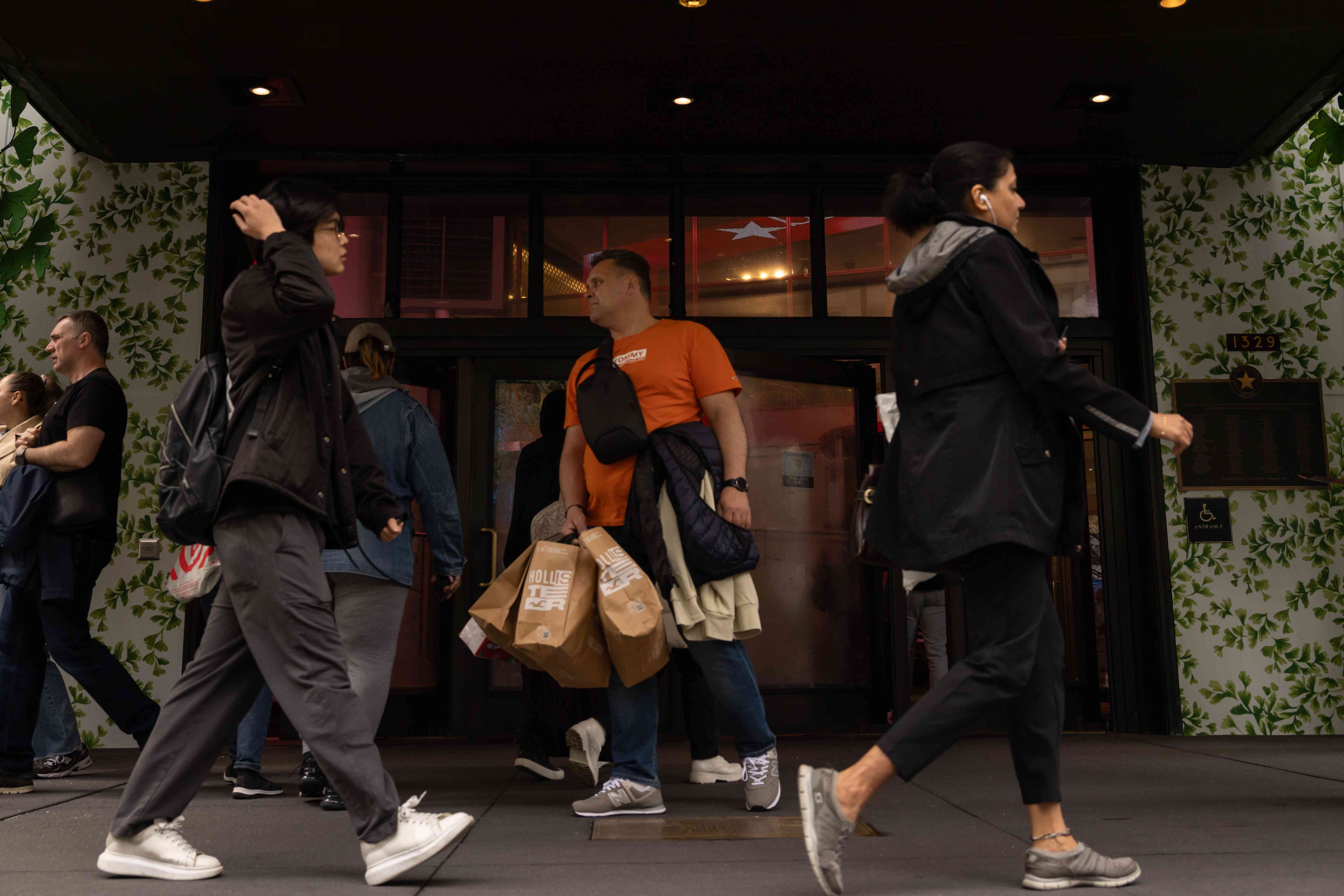 A shopper carries Hollister Co. bags outside of Macy's flagship store in the Herald Square neighborhood of New York, US, on Thursday, April 11, 2024. 